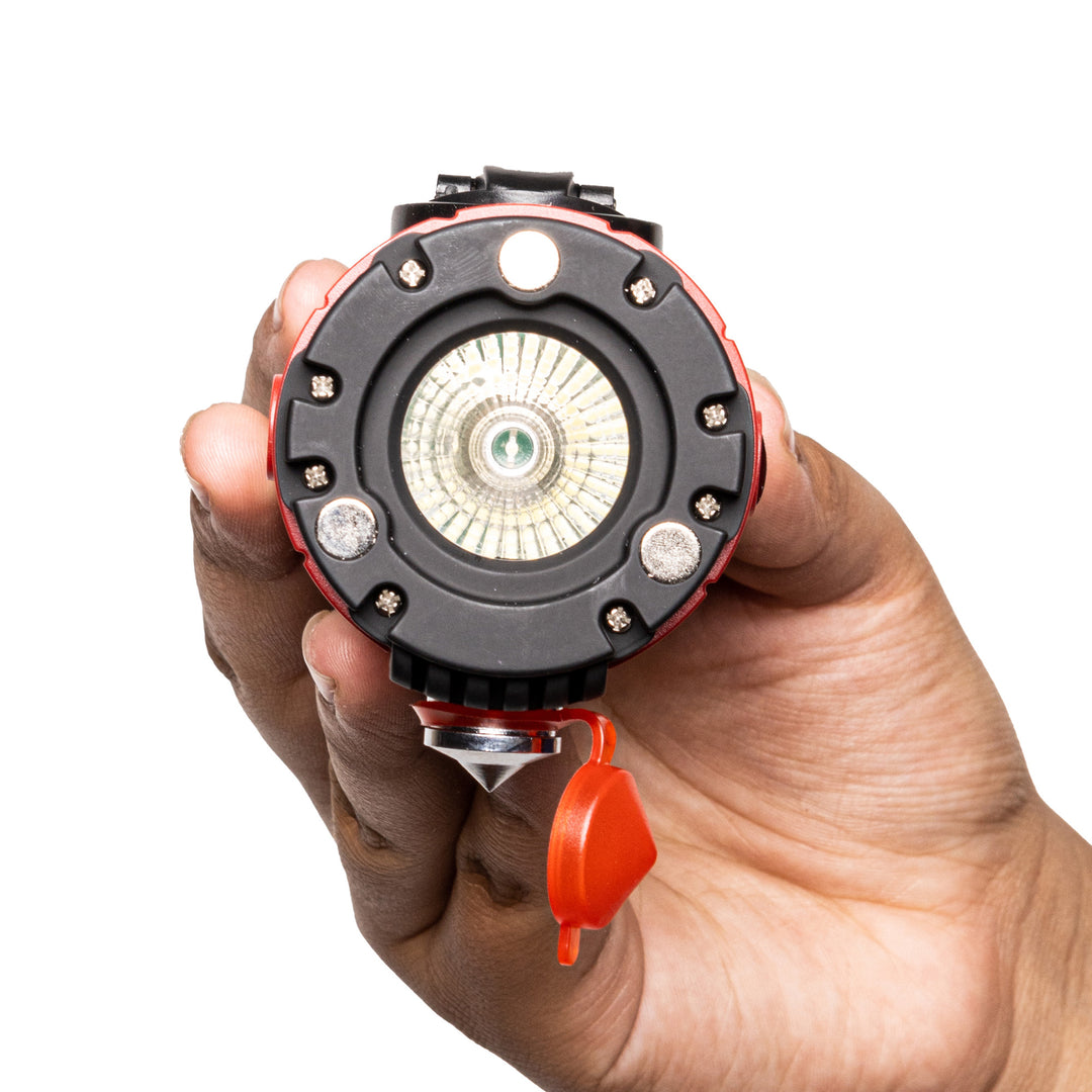 Man holding auto guardian auto flashlight with magnetic base, hand crank power with internal battery. Cell phone charging capable auto flashlight rescue tool.