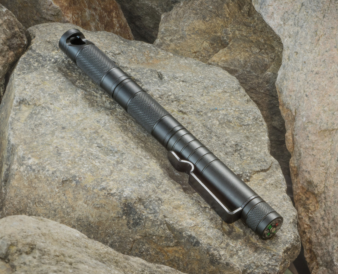 5 in 1 survival tool sitting on boulder during mountaineering