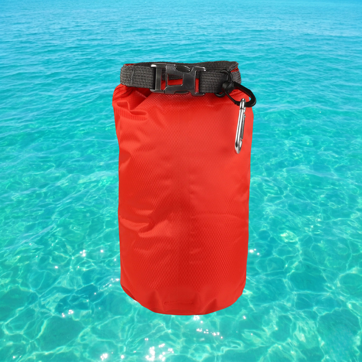 Red dry bag with a black strap and carabiner on clear blue water