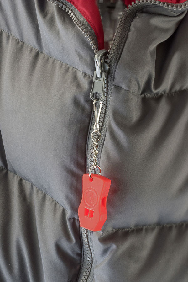 Whistlemania ICE warning whistle with keychain attached to coat zipper