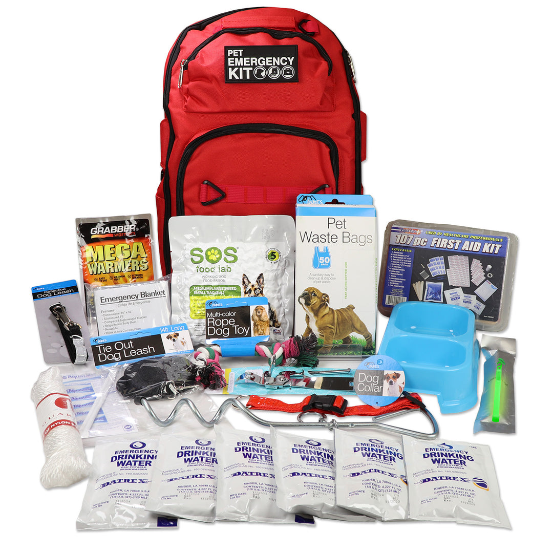 Red pet emergency kit with various supplies on a white background. Dog survival kit with dog food and water. 