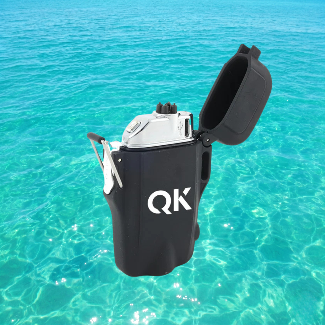 Black lighter with QK logo on a clear blue water background